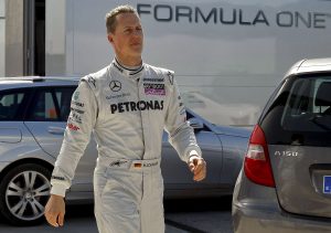 epa02041969 German Formula One pilot Michael Schumacher of the Mercedes GP team walks during the pactice session that is being held at the Jerez race track in Jerez de la Frontera, southern Spain on 19 February 2010.  EPA/JULIO MUNOZ